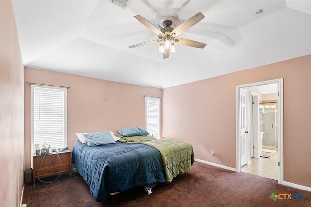 carpeted bedroom featuring visible vents, baseboards, ensuite bath, and vaulted ceiling