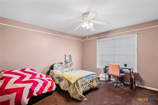 carpeted bedroom featuring baseboards and a ceiling fan