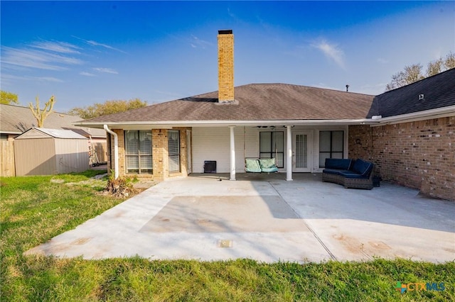 rear view of house featuring outdoor lounge area, a chimney, a storage shed, an outdoor structure, and a patio area