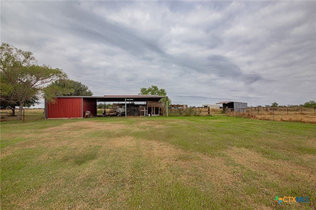 view of yard featuring an outbuilding and a rural view