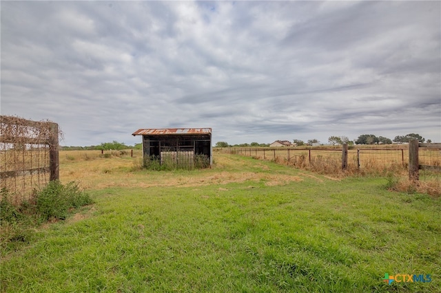 view of yard with a rural view