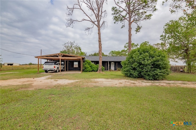 view of front of house with a front lawn and a carport