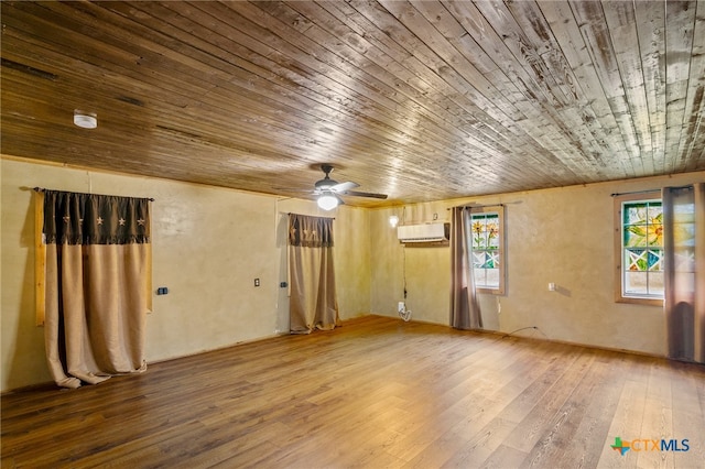 unfurnished room featuring a wall mounted AC, wood-type flooring, ceiling fan, and wooden ceiling