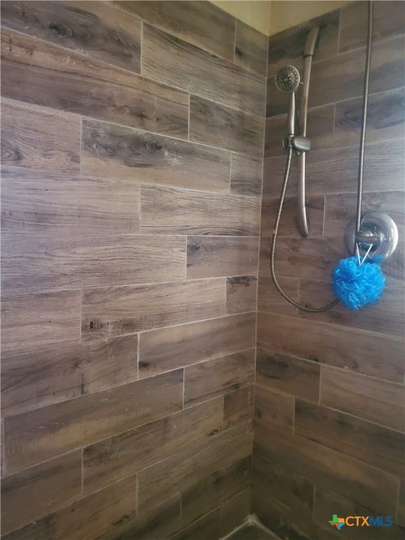 bathroom with tiled shower