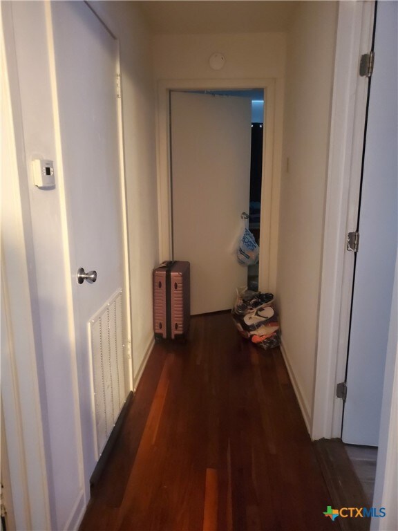 hallway featuring dark hardwood / wood-style flooring