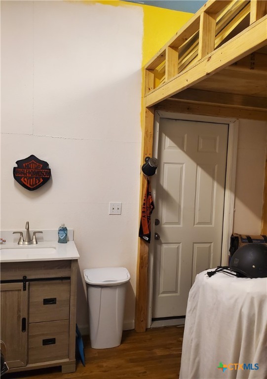 bathroom featuring vanity, hardwood / wood-style flooring, and toilet