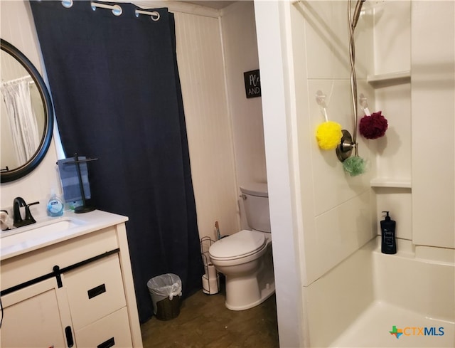 bathroom featuring walk in shower, vanity, toilet, and hardwood / wood-style flooring