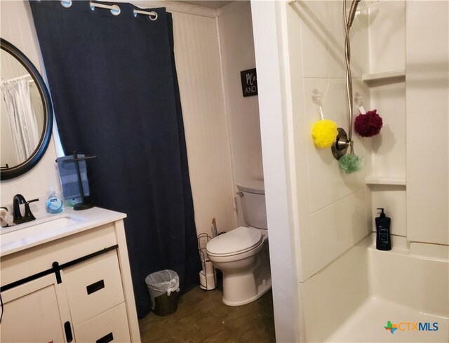 bathroom featuring walk in shower, vanity, toilet, and hardwood / wood-style flooring