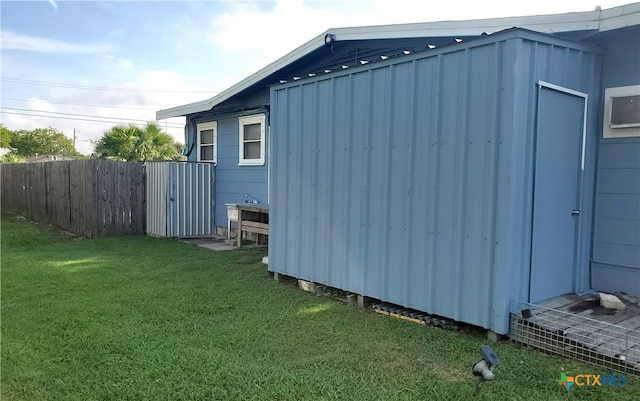 view of outbuilding with a yard