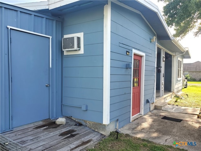 view of outbuilding with an AC wall unit