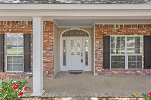 104 Twelve Oaks Dr, Temple, TX 76504 - property entrance featuring roof with shingles, covered porch, and brick siding