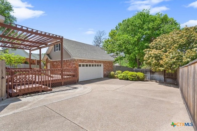104 Twelve Oaks Dr, Temple, TX 76504 - view of home's exterior featuring roof with shingles, fence private yard, a pergola, driveway, and brick siding