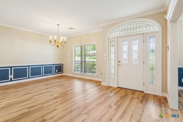 104 Twelve Oaks Dr, Temple, TX 76504 - foyer entrance featuring light wood-style floors, an inviting chandelier, ornamental molding, visible vents, and baseboards