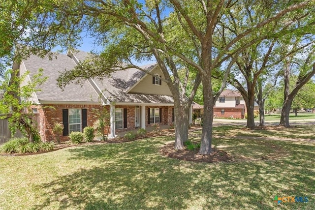 104 Twelve Oaks Dr, Temple, TX 76504 - view of front of house featuring a front yard, a shingled roof, and brick siding