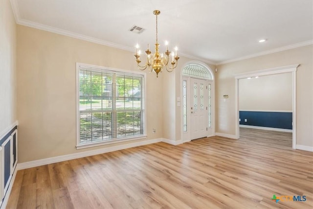 104 Twelve Oaks Dr, Temple, TX 76504 - entryway with light wood-style floors, crown molding, an inviting chandelier, visible vents, and baseboards