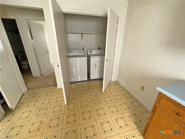 laundry room with light floors, laundry area, and washer and clothes dryer