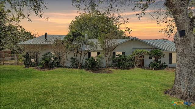 back house at dusk with a yard