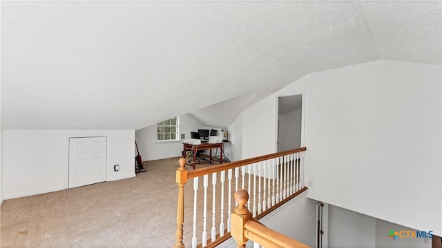 bonus room featuring lofted ceiling, carpet, and a textured ceiling