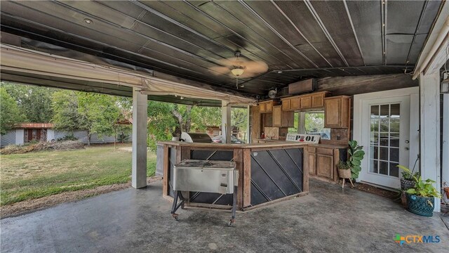 kitchen with sink, ceiling fan, a kitchen island, white cabinetry, and stainless steel appliances