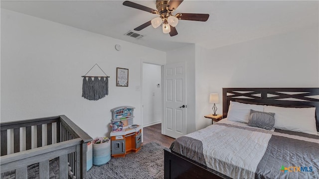 bedroom featuring hardwood / wood-style floors and ceiling fan