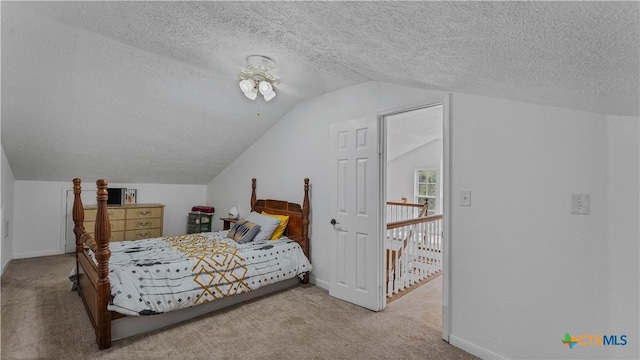 bedroom featuring lofted ceiling, light colored carpet, and a textured ceiling