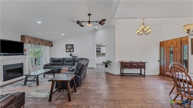 living room featuring lofted ceiling, dark wood-type flooring, and a chandelier