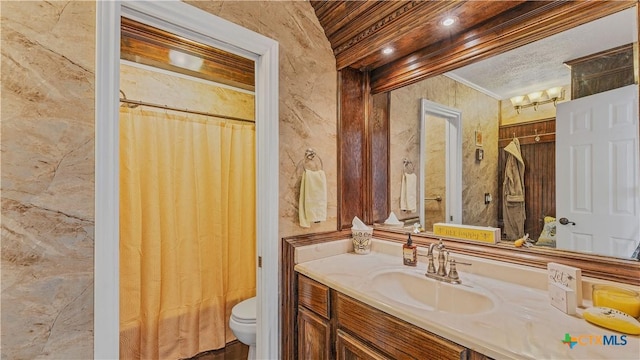 bathroom featuring vanity, ornamental molding, and toilet