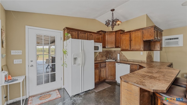 kitchen with a wall mounted AC, hanging light fixtures, a kitchen breakfast bar, kitchen peninsula, and white appliances