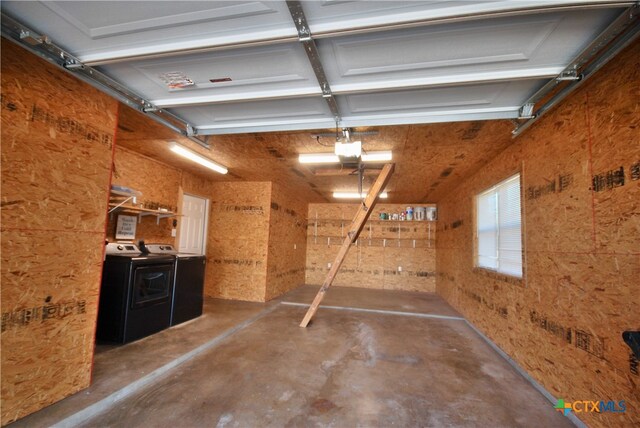 garage featuring a garage door opener and washer and clothes dryer