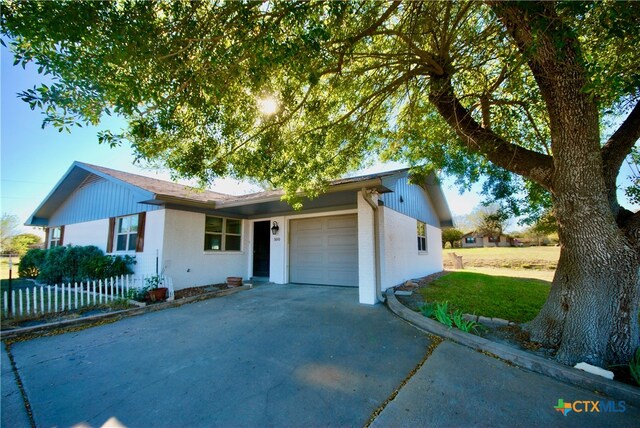 ranch-style house featuring a garage