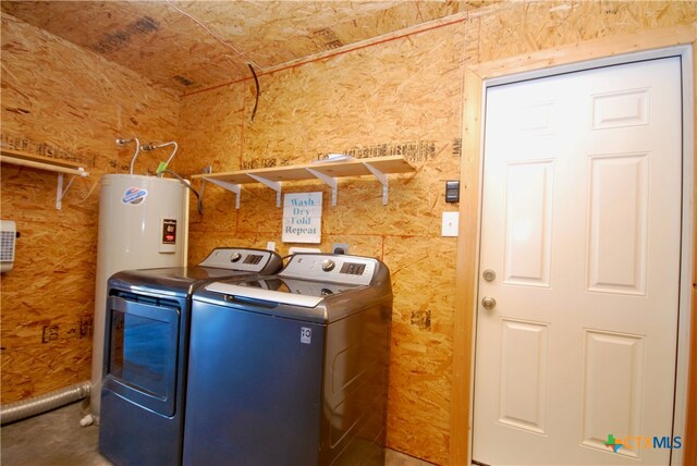 laundry room with washer and clothes dryer and water heater