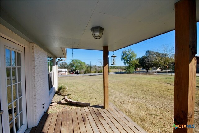 wooden deck with a yard