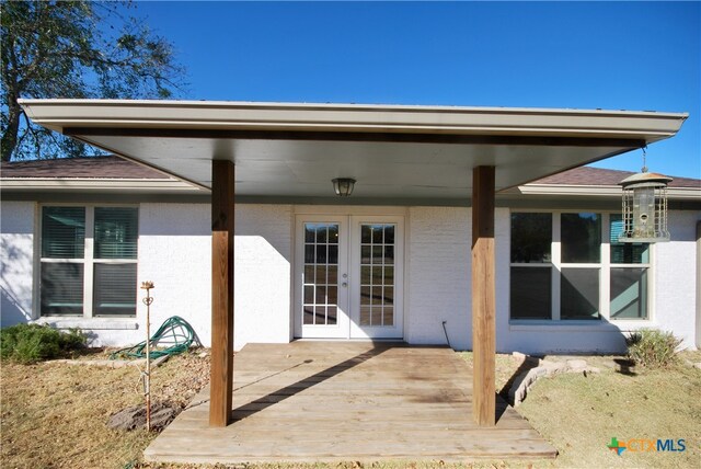 back of property with french doors and a wooden deck