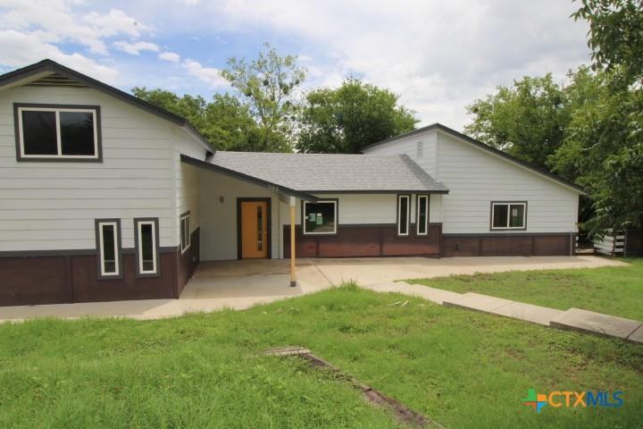 203 N Spring St, Lampasas, TX 76550 - rear view of property with a patio area and a yard