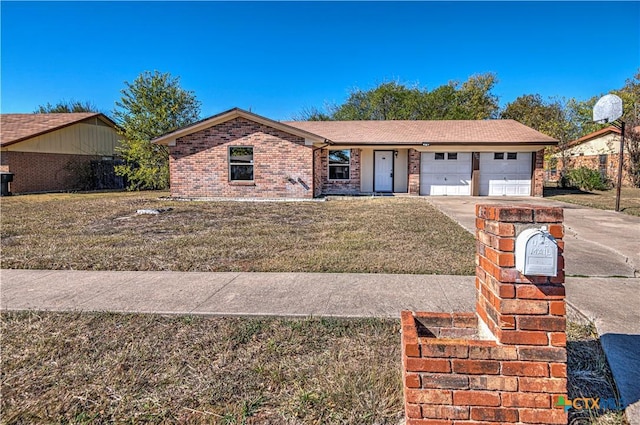 ranch-style house featuring a front yard and a garage