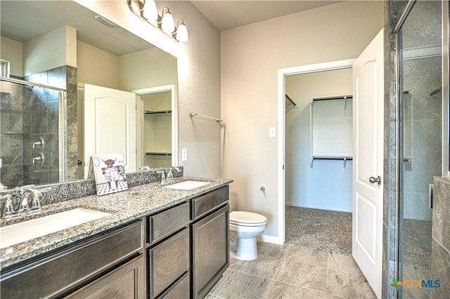 2002 Hayes St, Temple, TX 76502 - bathroom featuring double vanity, toilet, a sink, and a stall shower