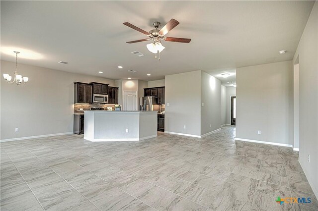 2002 Hayes St, Temple, TX 76502 - unfurnished living room featuring baseboards, ceiling fan with notable chandelier, and visible vents