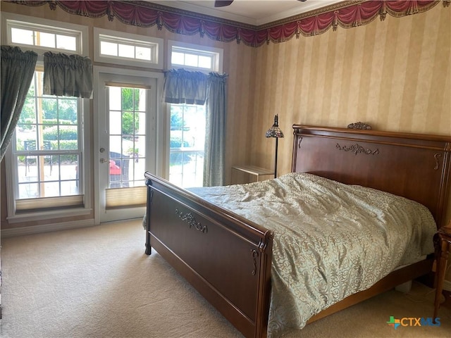 104 Woodcreek Cir, Victoria, TX 77904 - bedroom with wallpapered walls, access to exterior, and light carpet