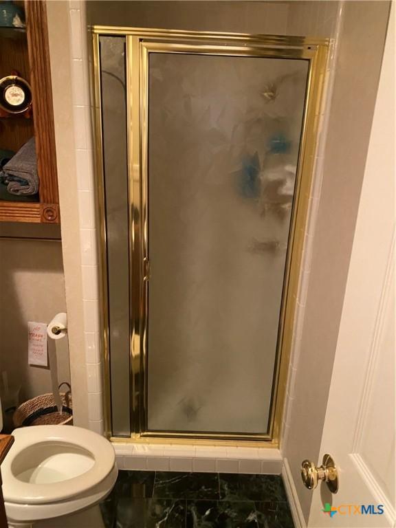 104 Woodcreek Cir, Victoria, TX 77904 - bathroom with a stall shower and toilet