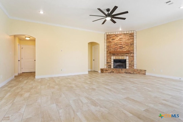 1129 Wren Cir, Copperas Cove, TX 76522 - unfurnished living room featuring arched walkways, ceiling fan, ornamental molding, a fireplace, and recessed lighting