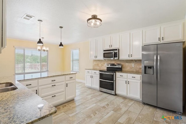 1129 Wren Cir, Copperas Cove, TX 76522 - kitchen featuring appliances with stainless steel finishes, tasteful backsplash, white cabinetry, and light stone countertops