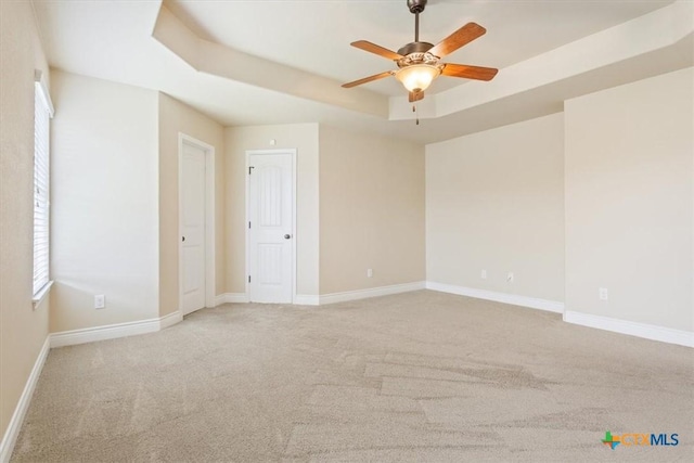 1129 Wren Cir, Copperas Cove, TX 76522 - empty room featuring a raised ceiling, light colored carpet, and a ceiling fan