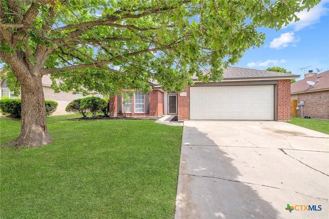 1808 Stratford Dr, Temple, TX 76502 - view of front of property with brick siding, an attached garage, driveway, and a front lawn