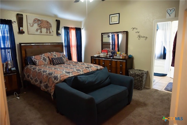 bedroom featuring ceiling fan, carpet, and lofted ceiling