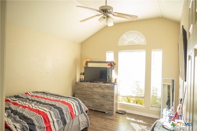 bedroom with ceiling fan, hardwood / wood-style floors, and vaulted ceiling