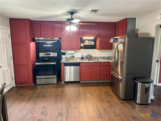 2503 E Mistletoe Ave, Victoria, TX 77901 - kitchen with stainless steel appliances, ceiling fan, dark wood-type flooring, under cabinet range hood, and a textured ceiling