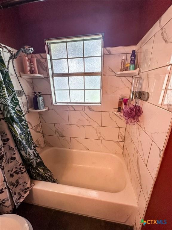 2503 E Mistletoe Ave, Victoria, TX 77901 - full bathroom featuring shower / bath combo with shower curtain and toilet
