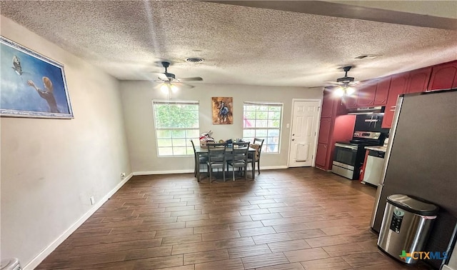 2503 E Mistletoe Ave, Victoria, TX 77901 - kitchen with ceiling fan, stainless steel appliances, under cabinet range hood, dark wood finished floors, and a textured ceiling
