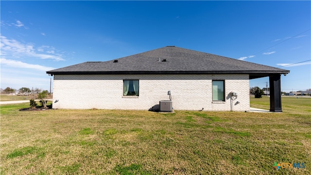 back of house featuring cooling unit and a yard