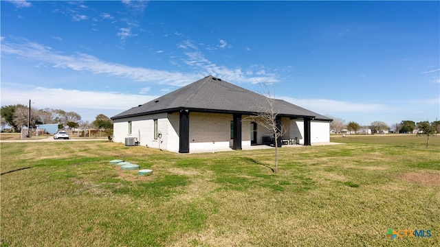 view of side of home featuring a yard and central air condition unit